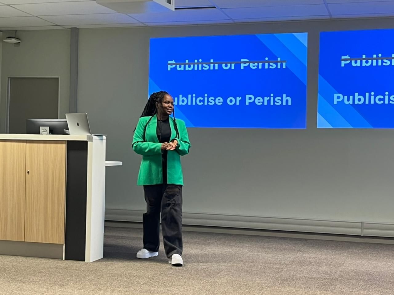 Ntsiki Sackey presenting 'Publicise or Perish' to a room, on the theme of getting research seen