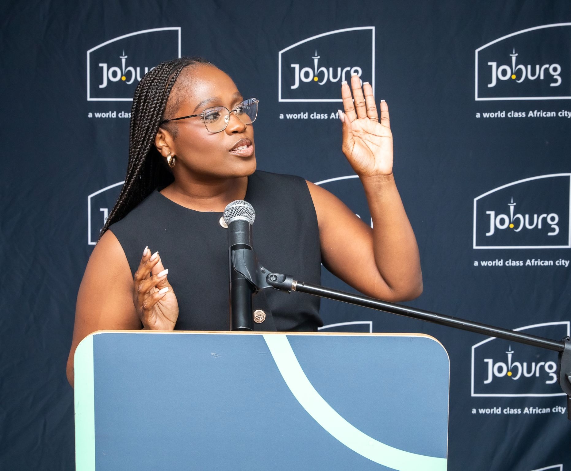 Ntsiki Sackey speaking at a podium at a Johannesburg event